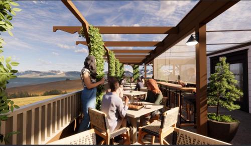 a balcony of a restaurant with people sitting at tables at Lightwell Hotel & Spa in Hood River