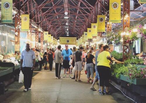 a group of people walking through a farmers market at Spacious 8BR-4BA Group HQ Patio&Games Soulard in Soulard