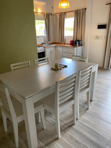 a kitchen with a white table and chairs at Villa La Soñada in Miramar