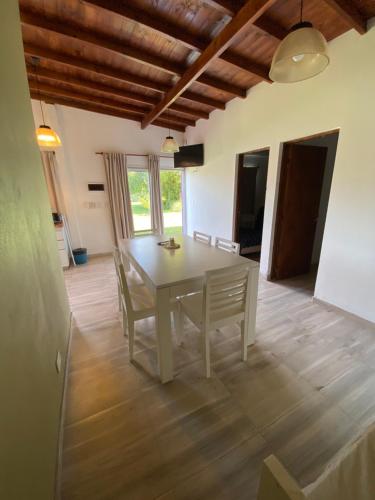 a dining room with a white table and chairs at Villa La Soñada in Miramar