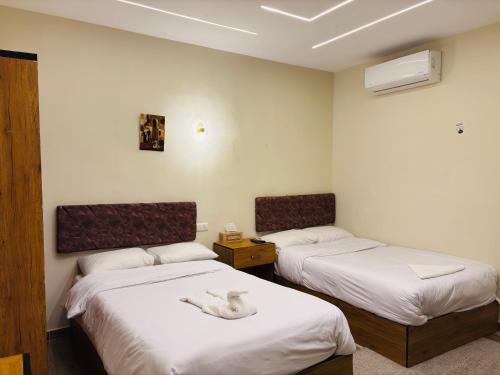 a room with two beds with a white swan sitting on them at The View Pyramids Gold Two in Cairo