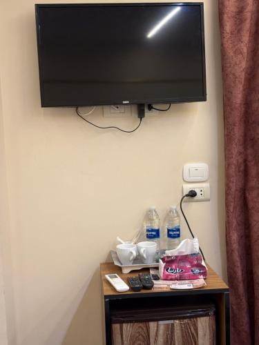 a flat screen tv hanging on a wall at The View Pyramids Gold Two in Cairo