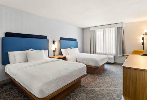 a hotel room with two beds and a window at Hampton Inn and Suites Merced in Merced