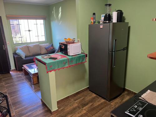 a living room with a refrigerator and a couch at mi rincón Paraná in Hernandarias