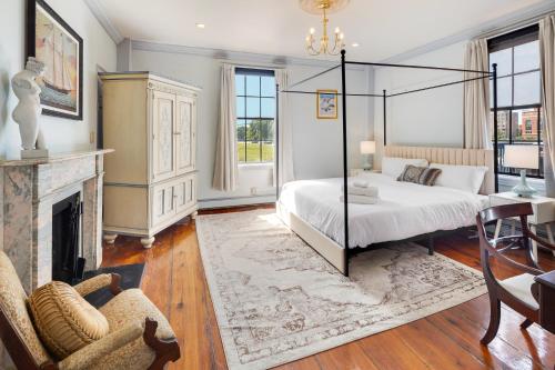 a bedroom with a canopy bed and a fireplace at The Hill in Providence