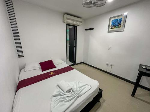 a bedroom with a bed in a room at HOTEL COLONIAL santorini colombiano in Doradal