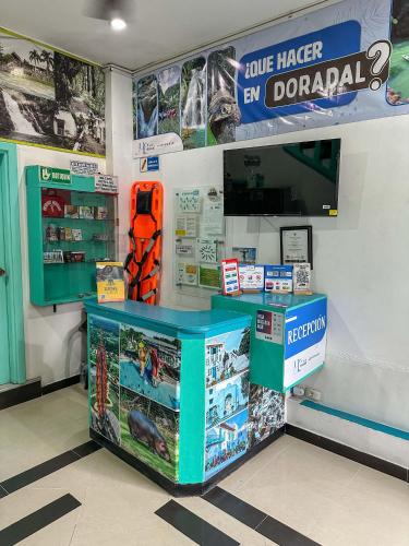 a store with a blue counter in a store at HOTEL COLONIAL santorini colombiano in Doradal