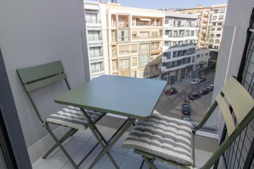 a table and two chairs on a balcony at Studio Confortable et Cozy - Maarif Casablanca in Casablanca