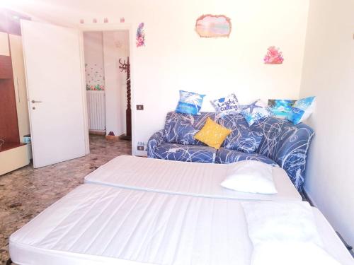a bedroom with a large bed and a couch at Oasi Relax Alassio Riviera in Alassio