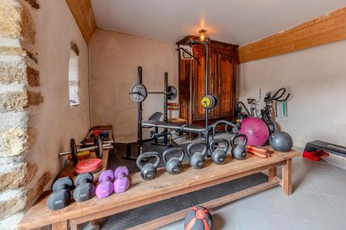 a room with a bunch of pots and pans on a shelf at Le gîte de Saint Mathieu, longère pleine de charme au bout du monde ! jacuzzi extérieur vue sur la campagne, salle de billard in Plougonvelin