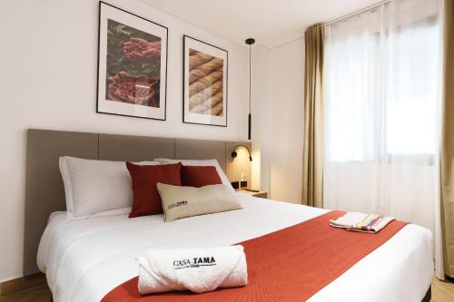 a bedroom with a large white bed and a window at Hotel CASA TAMA in Salento