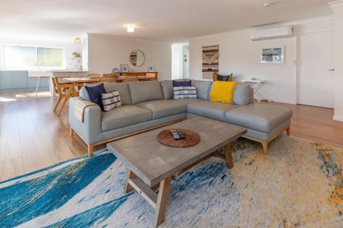 a living room with a couch and a table at Bangalow in Elizabeth Beach