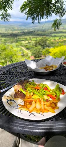 a plate of food with french fries on a table at Mirador Escondido del Chicamocha a 22km de Barichara in Villanueva