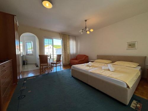 a bedroom with a bed and a living room at Apartments by the sea Kukljica, Ugljan - 24795 in Kukljica