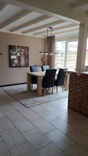 a dining room with a table and chairs at Family home near the city center! in Oudenbosch