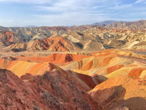 a view of a desert with red and brown mountains at KaoShan Tent Zhangye in Zhangye