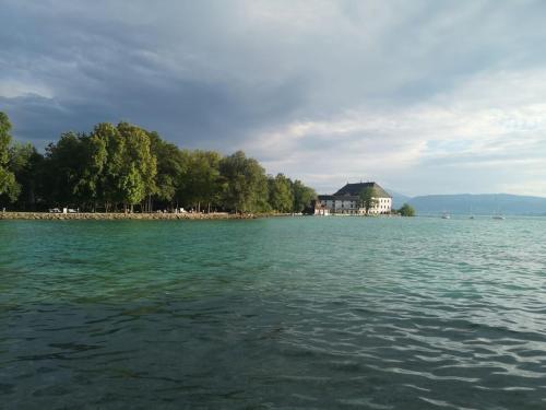 a large body of water with a house in the distance at One-bedroom apartment in Nussdorf am Attersee