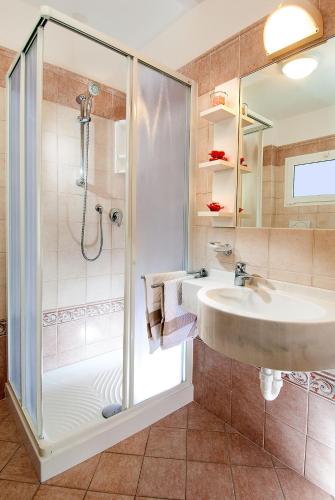 a bathroom with a sink and a shower at Hotel Alba Serena in Misano Adriatico