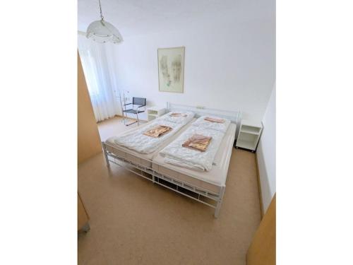 a bedroom with a bed in a white room at Holiday Home in Pfaffenweiler in Pfaffenweiler