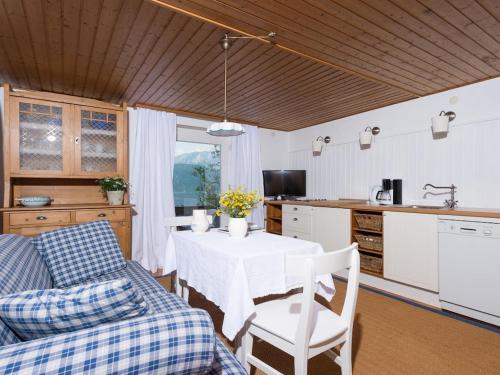 a kitchen and dining room with a table and a couch at One-bedroom apartment in Nussdorf am Attersee