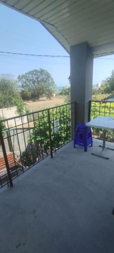 a balcony with a table and a bench on it at Bugazik in Karolino-Buhaz