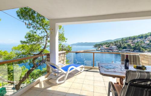 a house with a balcony with a view of the water at Holiday Home Prigradica 05 in Prigradica