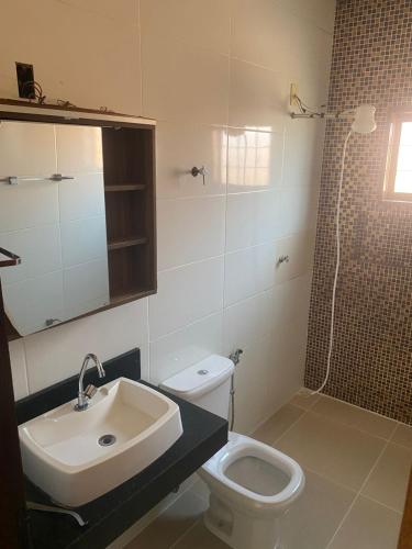 a bathroom with a sink and a toilet and a shower at Casa Bela Vista II in São Roque de Minas