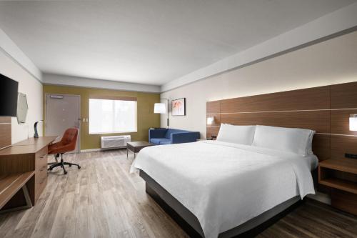 a hotel room with a large bed and a desk at Holiday Inn Express Hotel & Suites San Dimas by IHG in San Dimas