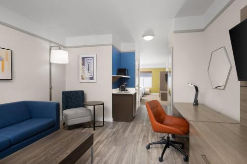a living room with a blue couch and a chair at Holiday Inn Express Hotel & Suites San Dimas by IHG in San Dimas