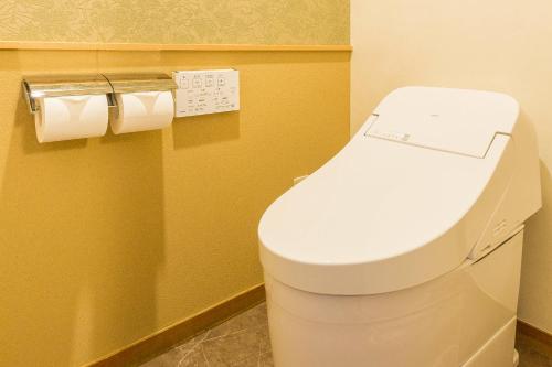 a bathroom with a toilet and two rolls of toilet paper at Hakone Yumoto Onsen Hotel Kajikaso in Hakone