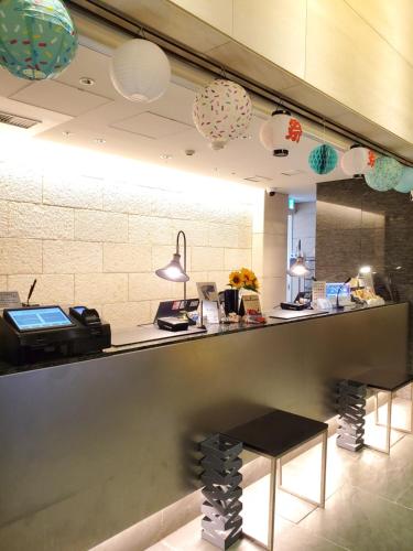 a restaurant with a counter with a phone and lights at Tokyu Stay Kamata - Tokyo Haneda in Tokyo