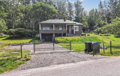 a house on the side of a road with a gate at Pet Friendly Home In Söderköping in Söderköping