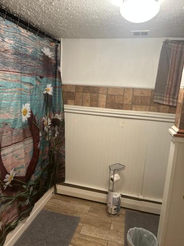 a bathroom with a mural of flowers on the wall at Slightwork in Gillette