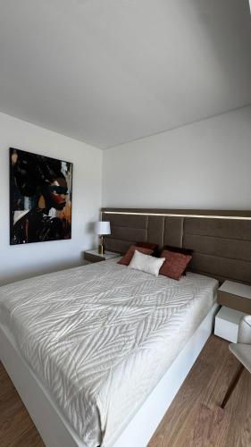 a white bedroom with a large bed in a room at Atlantic Golden View Luxe Apartment in Ponta Delgada