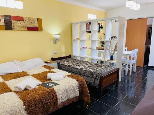 a bedroom with a bed and a table and chairs at Patta Tickan in El Peñón