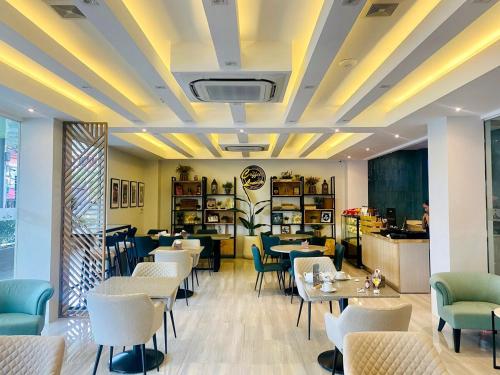 a restaurant with tables and chairs in a room at 1 Bedroom in Angeles City with gym and pool near Clark in Angeles