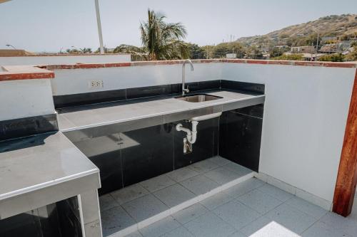 a kitchen with a sink and a view of a mountain at Zorritos beach house in Zorritos