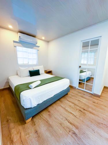 a bedroom with a large bed and a window at Zaba Beach House in San Andrés