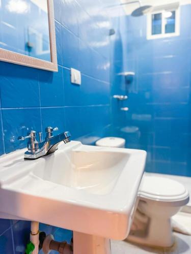 a bathroom with a white sink and a toilet at Zaba Beach House in San Andrés