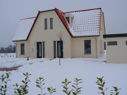 a house with snow in front of it at Holiday home in the Lüneburg Heath in Wietzendorf