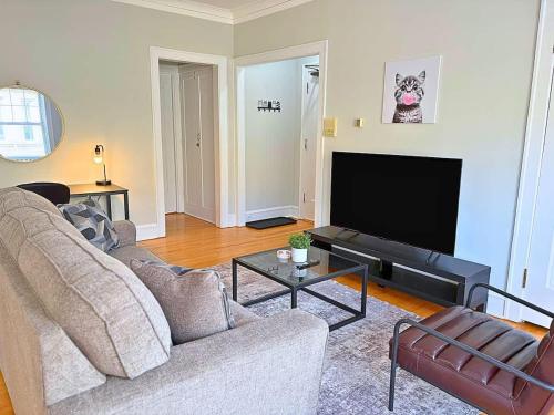a living room with a couch and a flat screen tv at Charming 1BR Apt in Evanston - Hinman B3 in Evanston