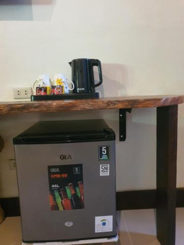 a table on top of a coffee machine under a counter at Sumatra Cheeky Monkeys Villa, Trekking and Tours in Bukit Lawang