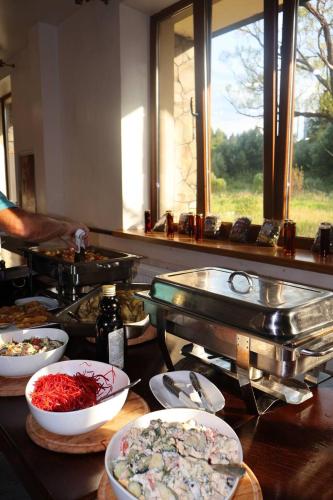 a buffet with bowls of food on a table at Готель TWINS РАЙ in Vorokhta