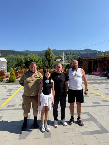 a group of people standing in a parking lot at Готель TWINS РАЙ in Vorokhta