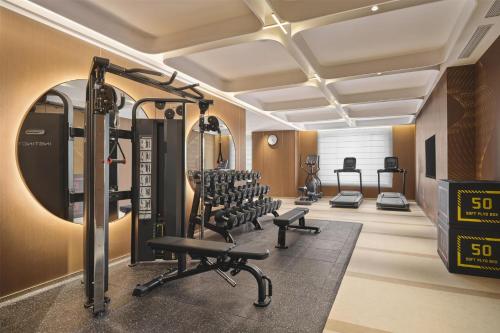 a fitness room with a gym with tread machines at Hilton Garden Inn Yingkou Zhanqian in Yingkou