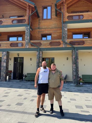 two men standing in front of a building at Готель TWINS РАЙ in Vorokhta