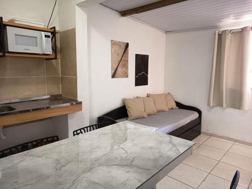 a living room with a couch and a table at Residencial Ponta Norte -Ponta das Canas in Florianópolis