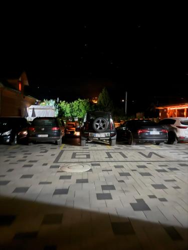 a group of cars parked in a parking lot at night at Готель TWINS РАЙ in Vorokhta