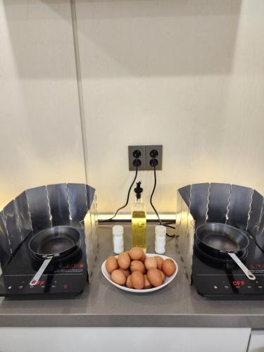 a kitchen counter with two toasters and a bowl of eggs at Giverny Hotel in Gyeongju