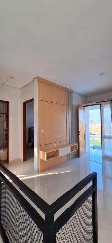 a large kitchen with a counter top in a room at Emerald Villa in Prampuan